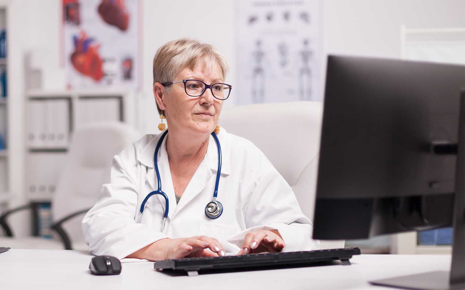 female doctor reviewing unrated medical malpractice insurance carrier on desktop