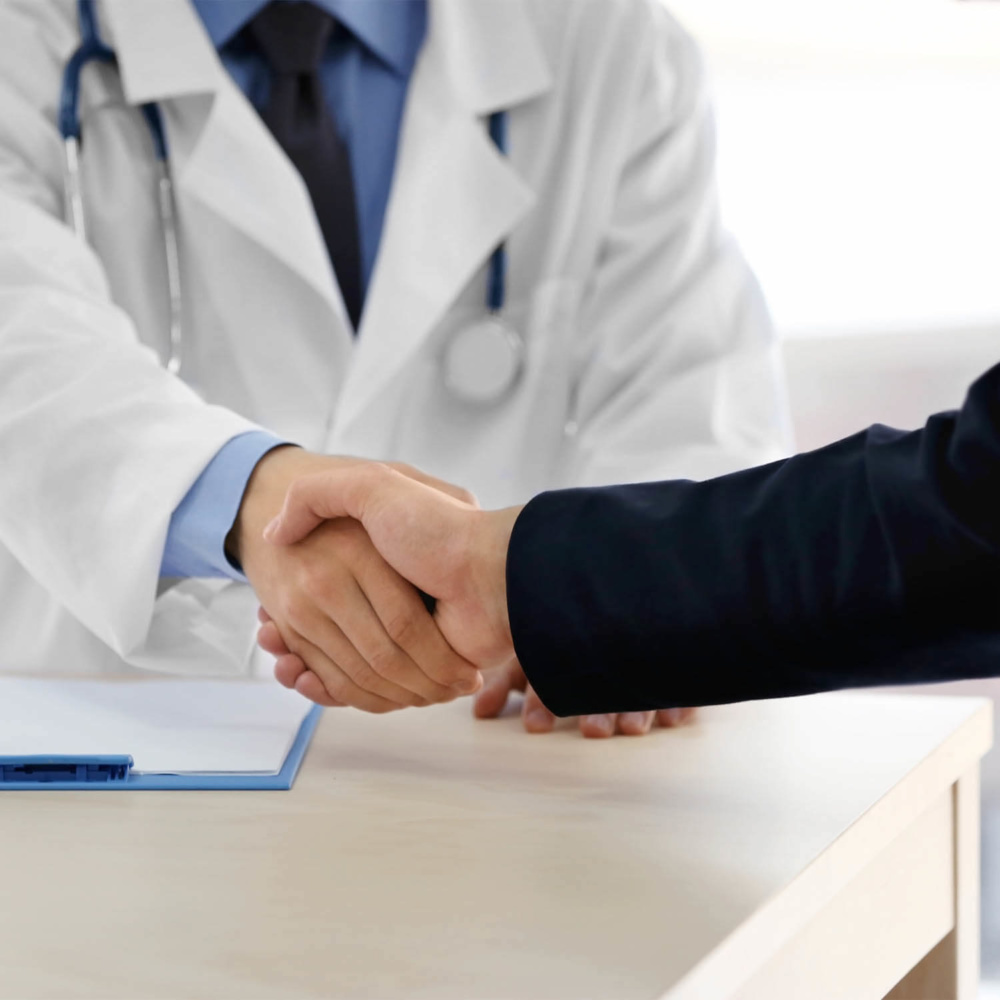 medical-facilities-coverage-image doctor shaking hands with insurance broker in medical clinic