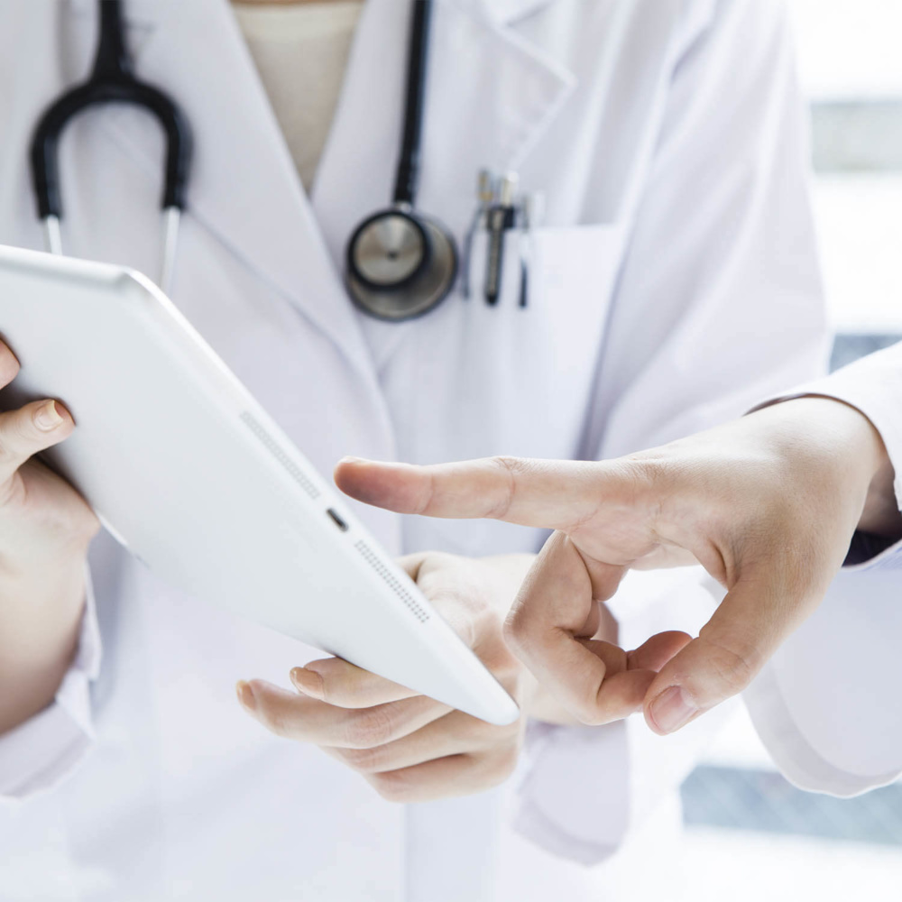medical-practice-risk-assessment-image doctors review risk assessment on electronic notebook