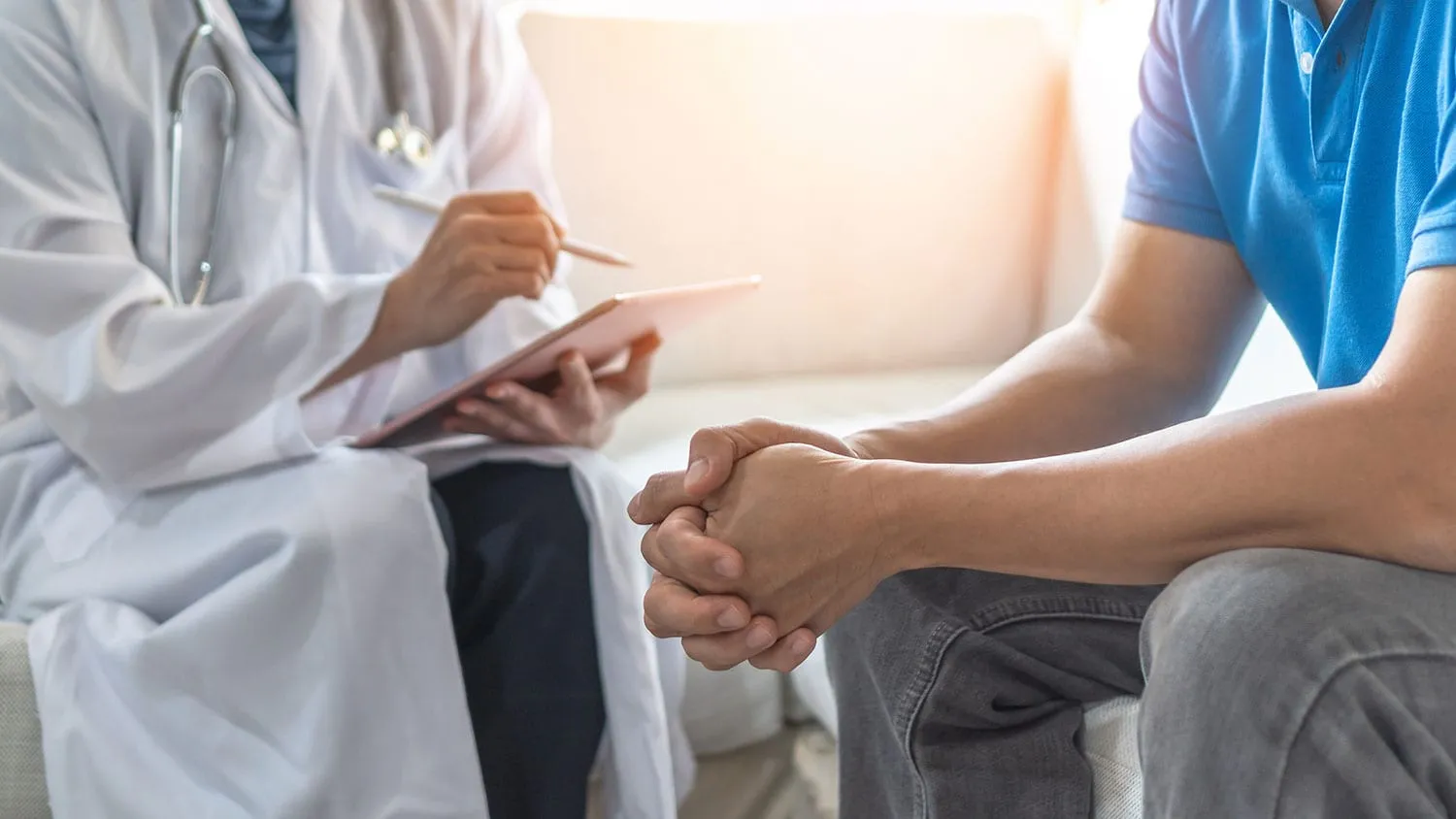 doctor-holding-clipboard-interviewing-casually-dressed-male-patient MEDPLI helps doctors who offer ketamine assisted psychotherapy to their patients find the best liability insurance