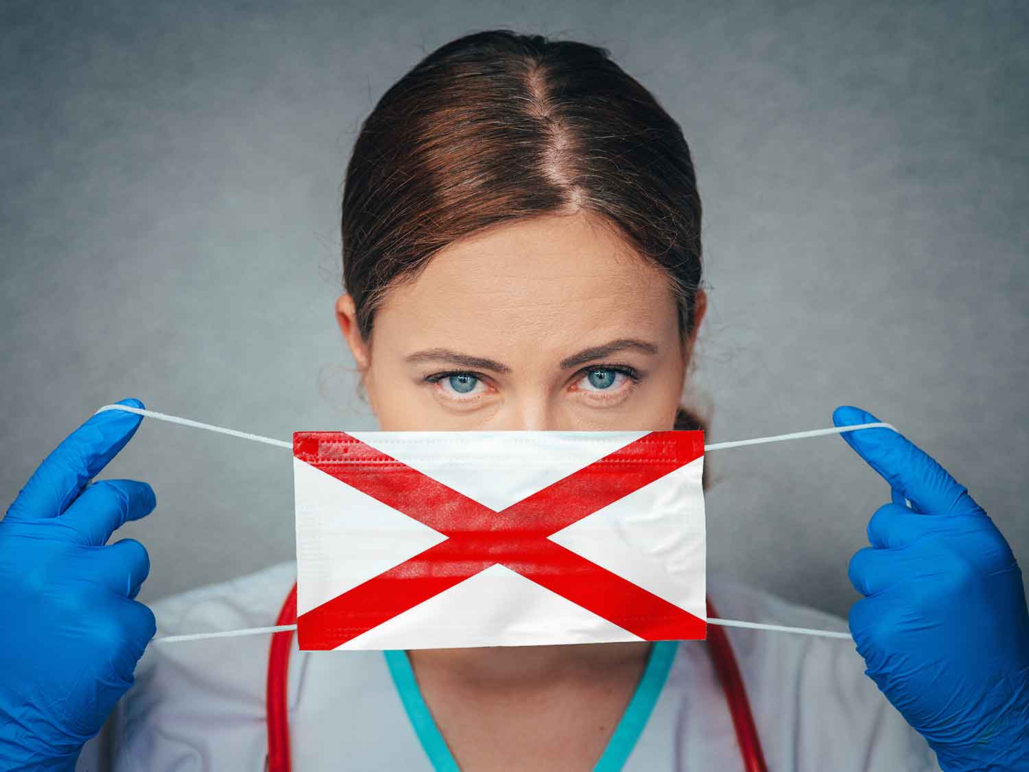 A Female Doctor With Medical Malpractice Insurance Putting On A Surgical Mask With The Alabama State Flag On It