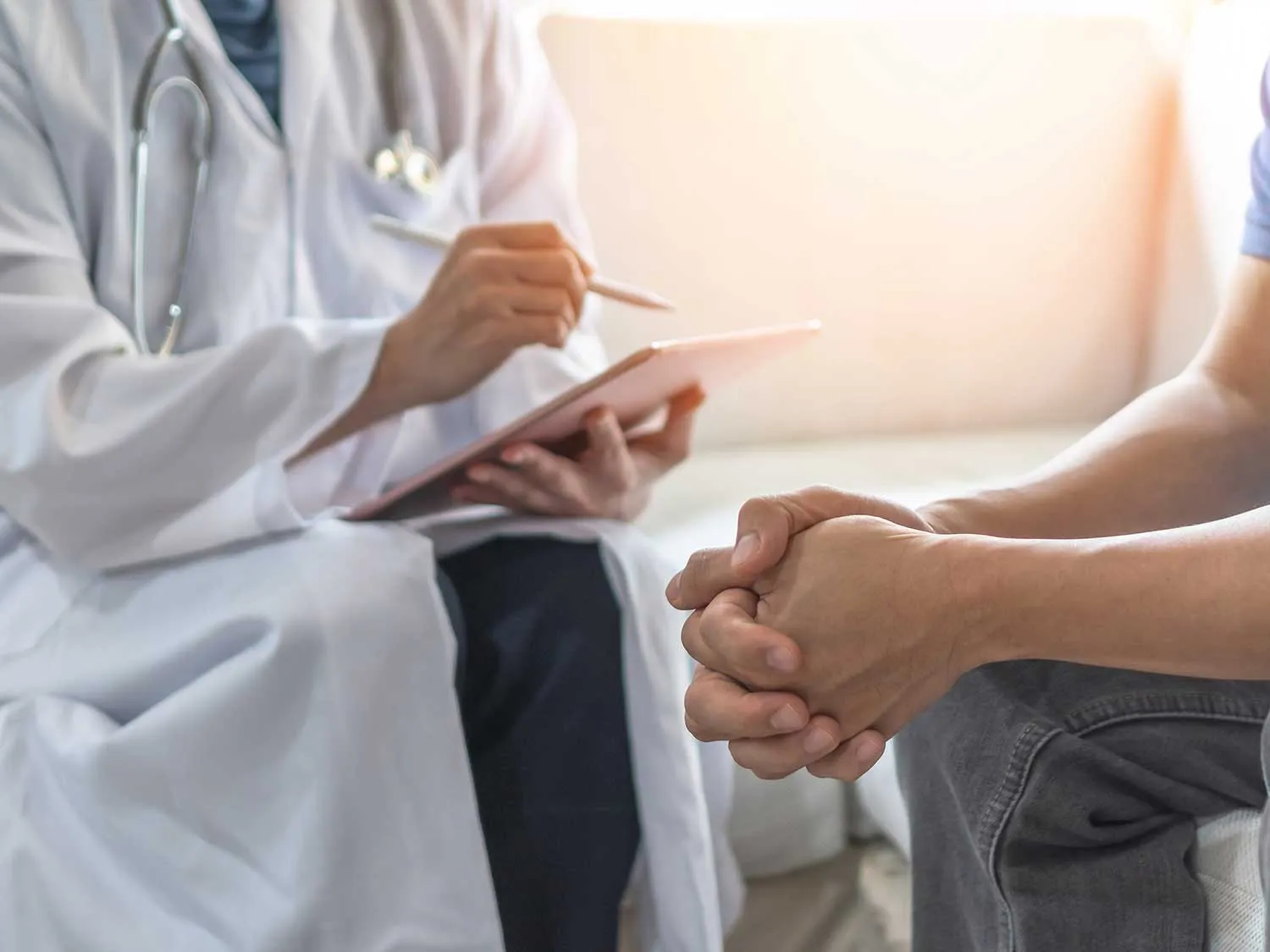 A Medical Professional Interviewing A Patient At Ketamine Infusion Clinic Covered By Medical Malpractice Insurance