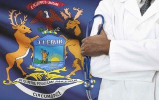 A Surgeon With Liability Coverage From MEDPLI Standing In Front Of The Michigan Flag