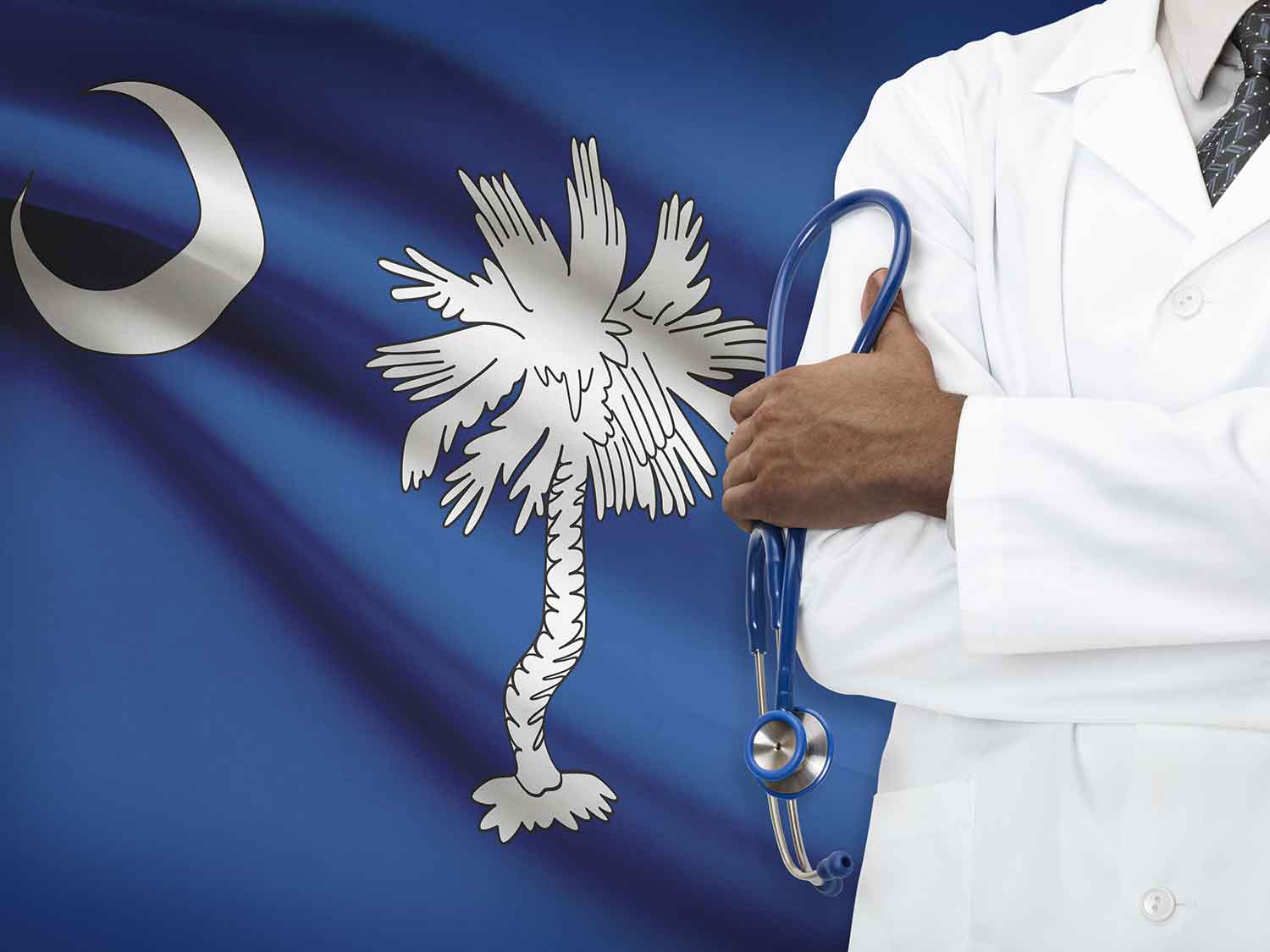 A Doctor With A Medical Malpractice Insurance Policy From MEDPLI Standing In Front Of The South Carolina Flag