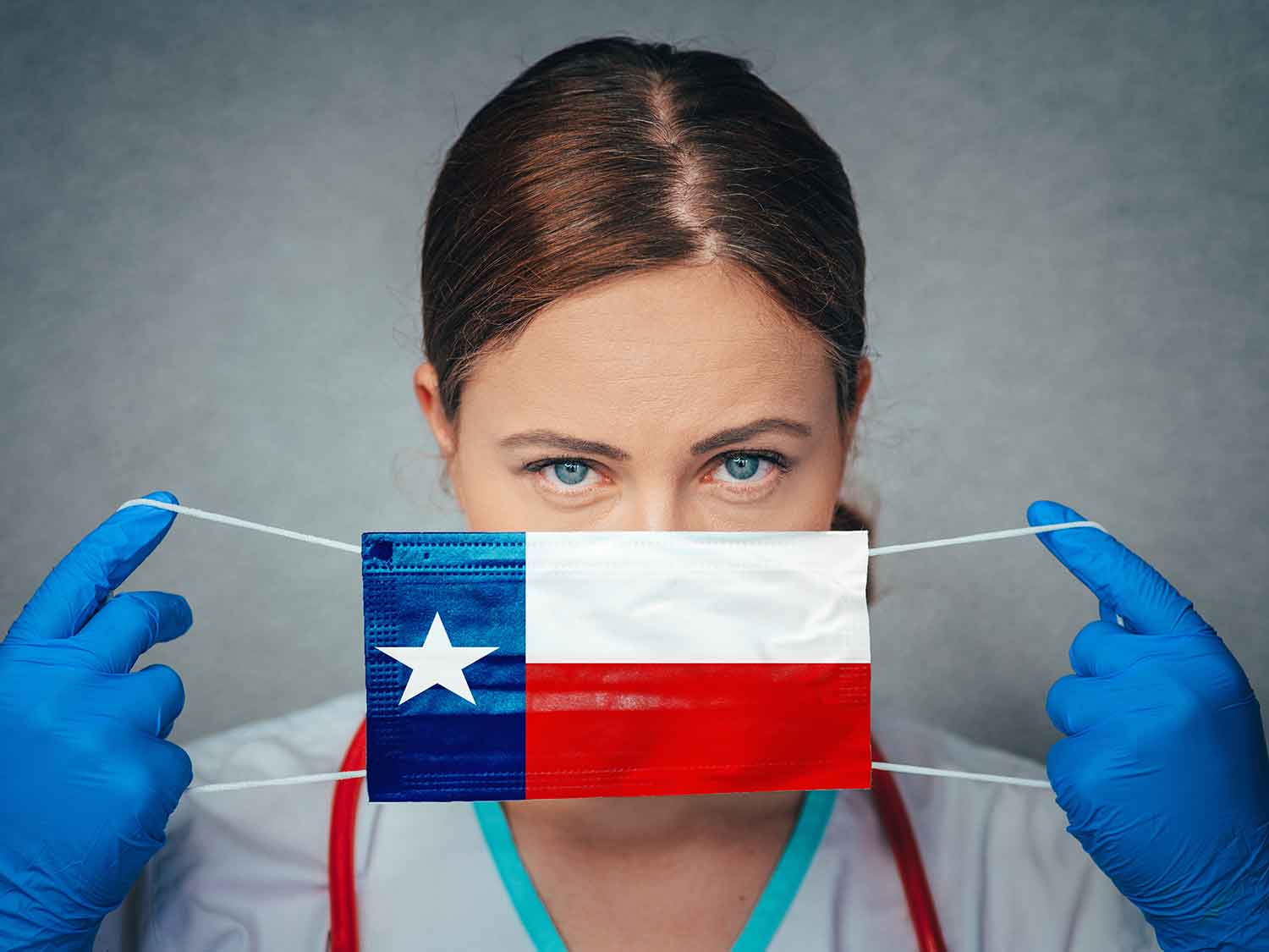 A Texas Doctor With Comprehensive Liability Insurance Holding A Mask With The State Flag Over Her Face