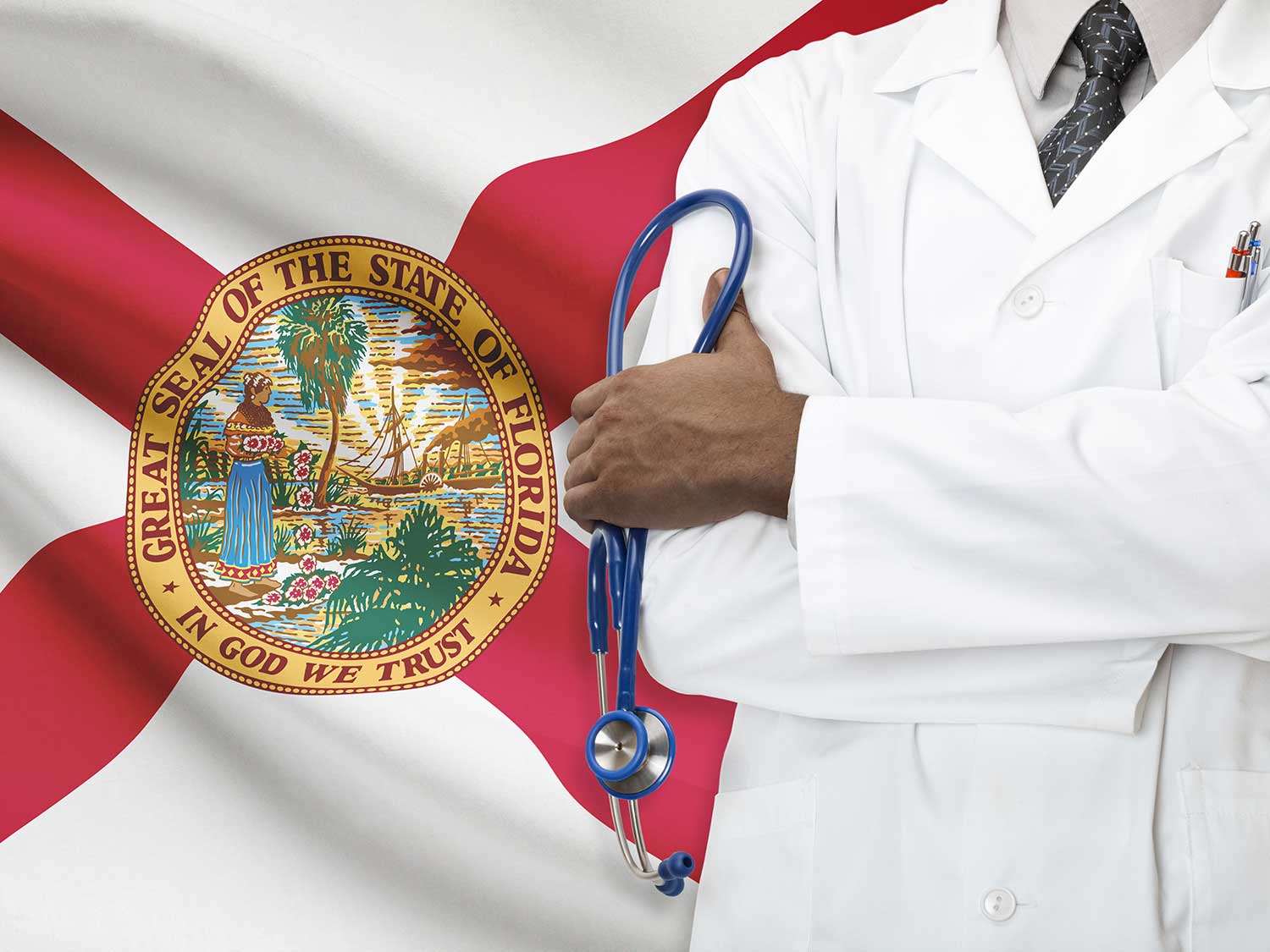 Surgeon Covered By Malpractice Insurance Standing In Front Of The Florida Flag With His Arms Crossed