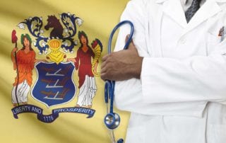 Doctor With Malpractice Liability Coverage Standing In Front Of A New Jersey Flag
