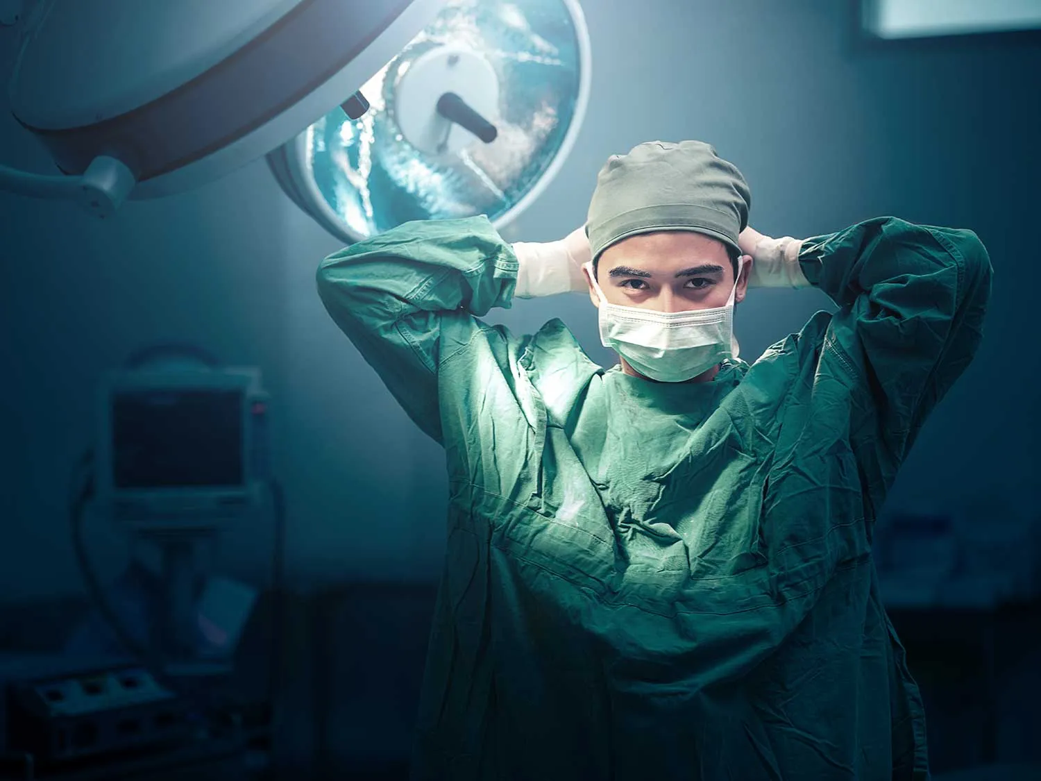 A Bariatric Surgeon With Medical Malpractice Insurance From MEDPLI Tying His Mask In A Surgical Room