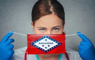 A Doctor With Medical Malpractice Insurance Placing A Arkansas Flag Surgical Mask Over Her Face