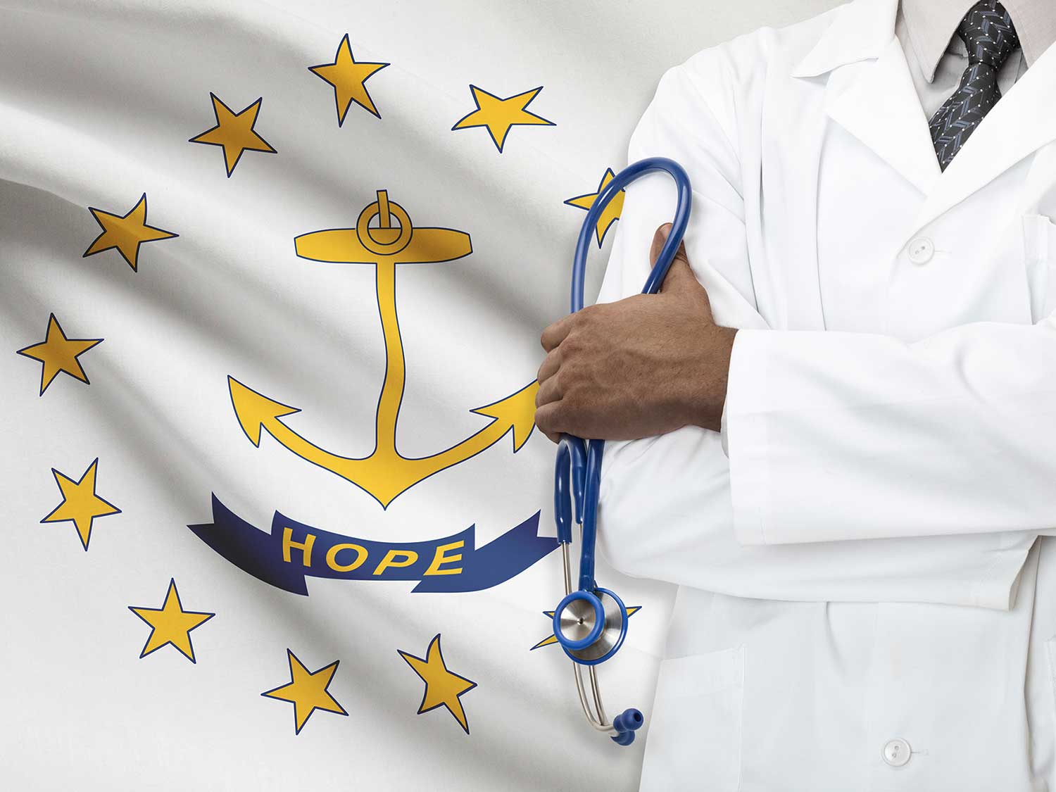 Rhode Island Doctor With Medical Malpractice Insurance Standing With His Arms Crossed In Front Of The State Flag