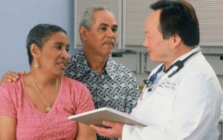 Doctor Consulting With Patient To Reduce Medical Malpractice Risk