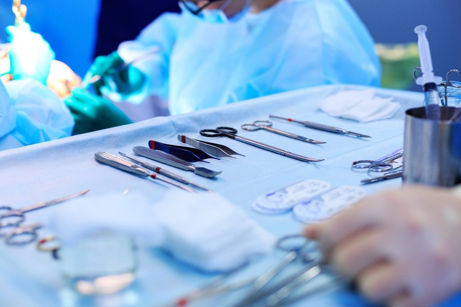 Clean plastic suregon tools laying out on a surgical table.